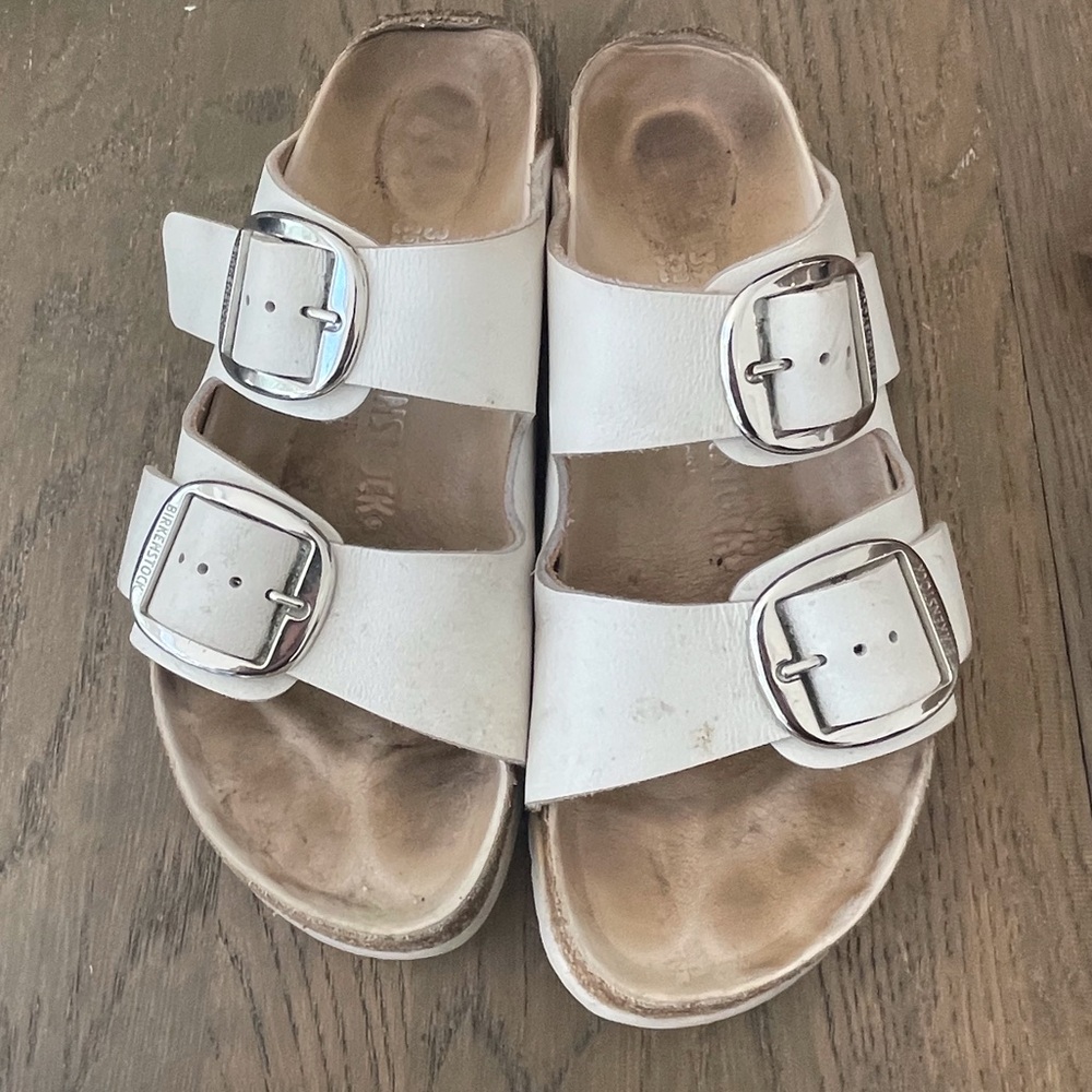 White Birkenstock sandals. Worn a bit but still very good.